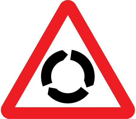 UK roundabout warning sign: a red-bordered triangle with three arrows forming a circle.