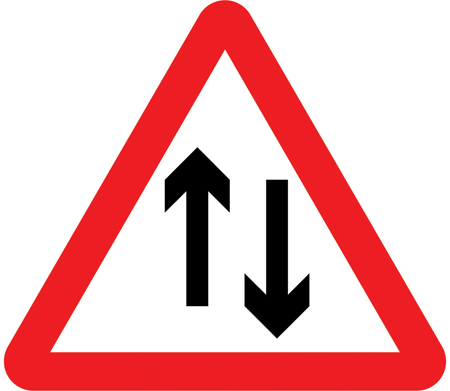 UK two-way traffic sign: a warning triangle with two vertical arrows pointing in opposite directions.