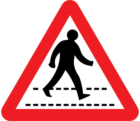 UK zebra crossing warning sign: a triangle showing a person walking on black and white crossing stripes.