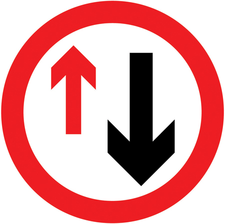 UK priority sign: a red-bordered circle with a large black upward arrow and a smaller red arrow.