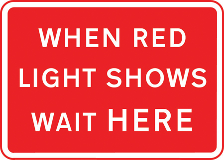 Vehicles may not pass the temporary traffic signals when the red light is shown sign