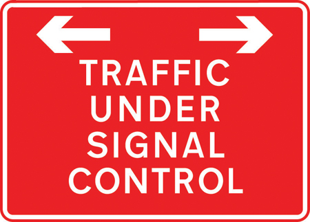 Traffic on road ahead is being controlled by portable light signals sign