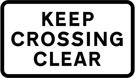 UK sign prohibiting vehicles from stopping within the area of a railway or tramway level crossing.