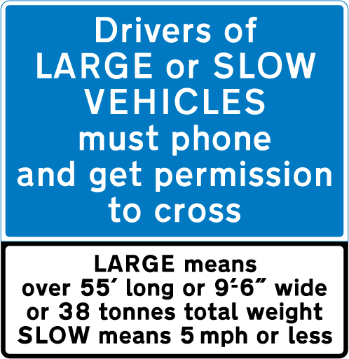 UK sign instructing drivers of large or slow vehicles to stop and telephone before using an automatic level crossing.